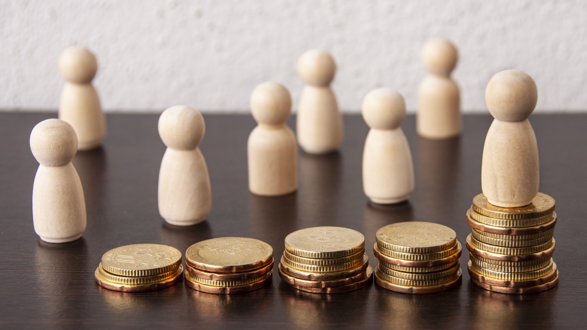Coins Stack with wooden doll model background - Business and Financial Concept